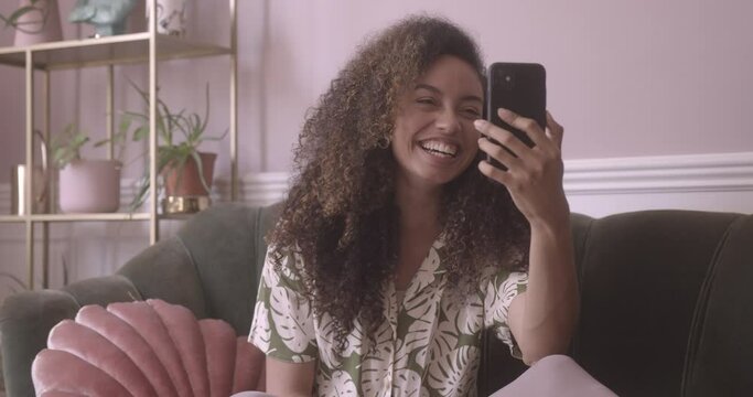 Young adult female using a smartphone for a video call 