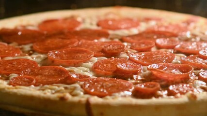 PANNING Timelapse of pepperoni pizza cooks in oven