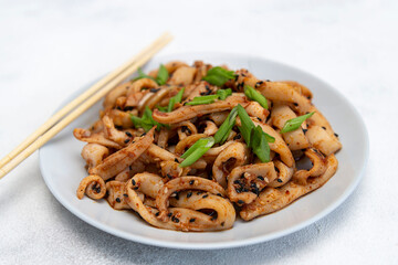 Seafood salad of squid on the grey plate. Macro. On grey background. korean dish.asian dish.