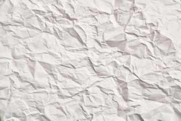 White crumpled paper texture with wrinkles. Damaged and torn sheet