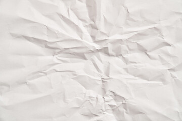 White crumpled paper texture with wrinkles. Damaged and torn sheet