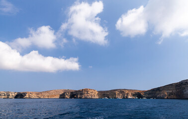 Fototapeta na wymiar Pleasure boats near coastal caves of the Blue Lagoon, Malta