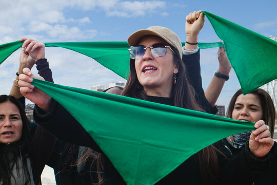 Green wave abortion: Hispanic women with green scarves on reproductive rights and safe end pegnancy protest in Latin America