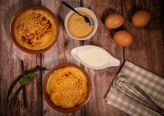 Chef cooks creme brulee with gas burner, dessert in the home kitchen, Cooking at home, professionals for food blog. High quality photo