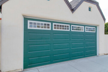Garage exterior with green sectonal door at La Jolla, California