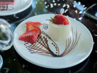 cake-dessert with strawberries on a plate in a restaurant. Close-up