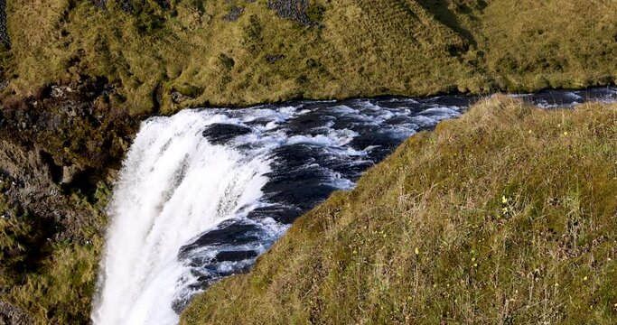 4K High-resolution Slow Motion Video Of Water Going Over The Edge Of Skógafoss Waterfall During Daytime.