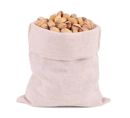 Roasted salty pistachios nuts in burlap sack bag isolated on white background