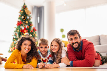 Parents and children celebrating Christmas at home