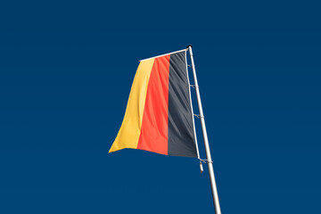 The German flag with blue sky.