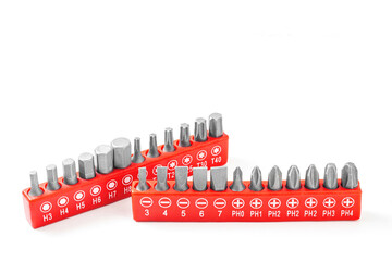 A set of steel bits for screwdrivers of various sizes and shapes in red cases close-up on a white background with a shadow.
