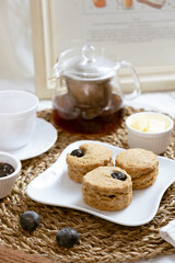 Delicious blueberry Scones on white cafe table.