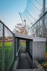 Obraz premium Baseball dugout, protection fence, and screens, external view.
