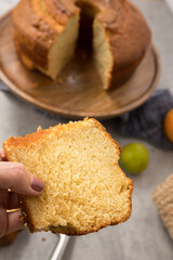 Closeup view of a perfect sponge slice of cake taken by a very well care woman hand.
