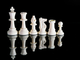 White Chess Pieces on a black background