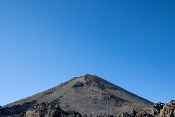 Hiking and trekking Teide volcano in Tenerife, Canary Islands. Scenic panorama of the tip of Teide (pico del teide) and rocky natural park. Natural park view and original landscape for adventures