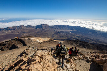 Fototapeta premium Hiking and climbing in top of the mountain. Trekking experience on Teide Volcano in Canary island Tenerife. Pico del Teide climbing
