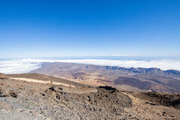 Fototapeta na wymiar Hiking and trekking Teide volcano in Tenerife, Canary Islands. Scenic panorama of the tip of Teide (pico del teide) and rocky natural park. Natural park view and original landscape for adventures