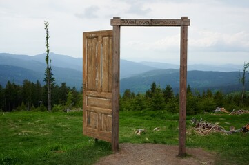 Fototapeta premium Wooden door in the mountains. Door to Šumava. We love Šumava.