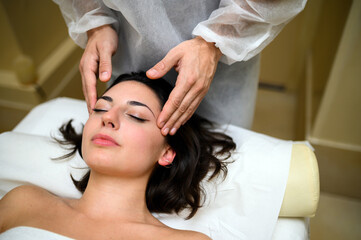 Obraz na płótnie Canvas Woman having a face massage in a spa