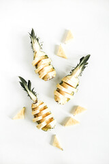Sliced pineapple on white background. Flat lay, top view tasty fruit arrangement
