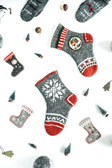 Craft felt Christmas socks, stockings and Christmas ornaments decorations on white background. Cozy aesthetic holiday celebration setting. Flat lay, top view