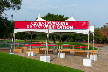 Covid-19 Vaccine or Test Verification sign on banner at the outdoor entrance to public event on stadium