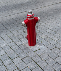 Fire hydrant red color on a cobblestone background.