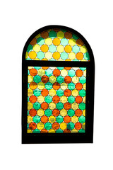 Antique window with many colored round glass in orange, yellow and green.