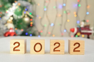 Happy New Year 2022 on wood cube block on the desk