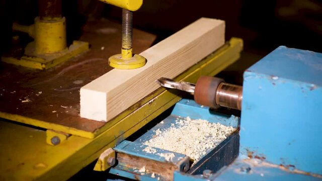 Making a groove for a tenon connection on a slotting machine. Joinery works.