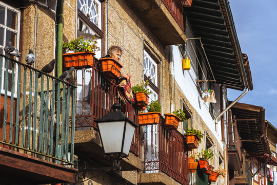 Old lady on the balcony of an apartment