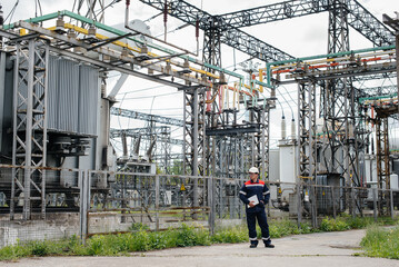 The energy engineer inspects the equipment of the substation. Power engineering. Industry