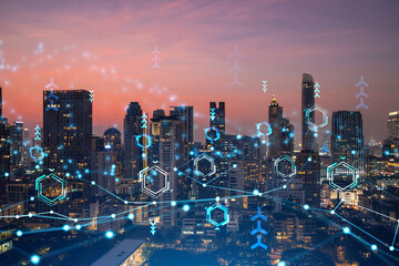 Glowing hologram of technological process, aerial panoramic cityscape of Bangkok at sunset. The...