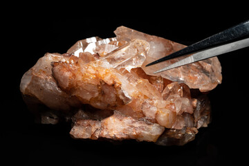 Natural Quartz crystal cluster on black background, selective focus. Pure crystalline mineral....