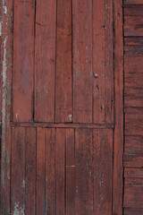 Old wooden wall with remnants of red paint. Texture of old wooden boards.