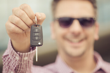 Male hand holding car key