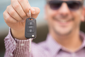 Close up of man, holding car keys.