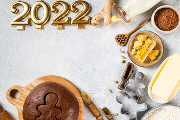 Christmas Baking background. Ingredients for cooking christmas baking on light background. Top view with copy space. Gingerbread cookies. Baking Ginger cookies. Raw dought for cookies. Number 2022