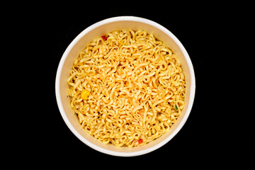 Instant Noodles in Disposable Cup on Black Background - Top View. Asian Fast Food. Quick Lunch