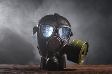 Gas mask in the smoke close up. Air pollution.