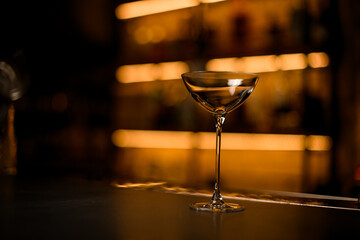 selective focus on beautiful clean glass on a bar counter on a blurred background