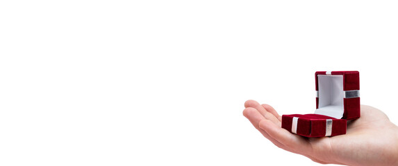 Man's hand holds opened red box isolated on white background. Wedding concept. Valentine's day....