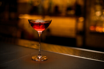 great view of beautiful glass on long leg with bright red drink on the table