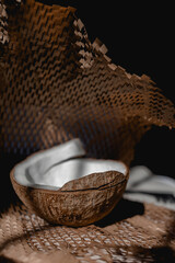 Fototapeta premium Half coconut on the table on paper. Front view.