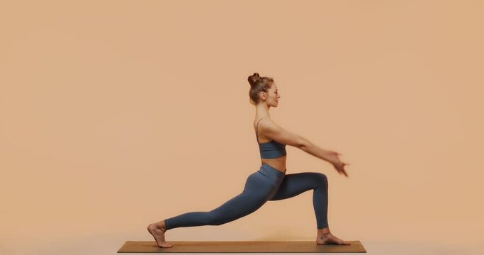 Yoga pilates stretching workout. Young fit girl exercise performing lunge pose in studio for perfect healthy body, spine