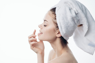 woman after shower with towel on head posing skin care