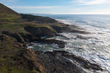 Fototapeta na wymiar The cold Pacific Ocean washes onto the rugged coastline of Northern California north of Fort Bragg. The Pacific Coast Highway runs right along this scenic region in Mendocino County.