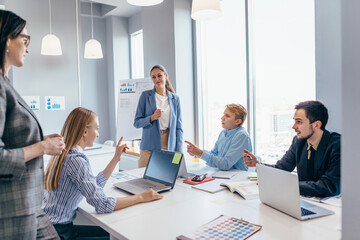 Businesswoman briefing her colleagues in office. Businesspeople working.