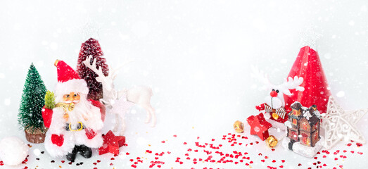 Santa, Christmas deer and festive decorations on table. Christmas still life web banner